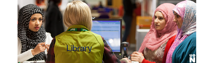 Students seeking help from a Library Customer Services Assistant