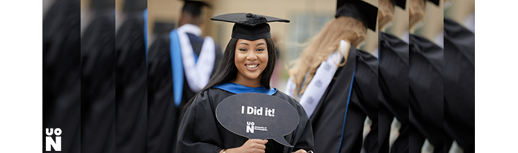 Graduate holding a sign saying I did it